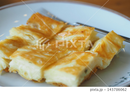 Slices of freshly baked cheese turkish borek pastry, neatly arranged and served on a plate 143786062