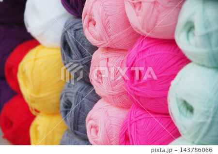 Stacks of yarn skeins in assorted colors at a craft supply shop 143786066