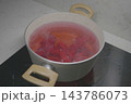 beetroot boiling in a pot of water on a stove. 143786073