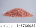 Pink salt crystals piled on a surface in a studio setting 143786085