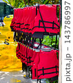 Red Life Jackets Hanging on Storage Rack at Water Park 143786997