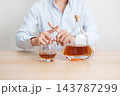 Man making stop hand gesture to refuse a glass of Cognac, Healthy man say no to alcohol drink, stop alcoholism and addiction concept. Responsible man reject a drink before driving and quit booze 143787299