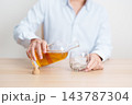 man pour whiskey into a glass on table, suffering from alcohol addiction, alcoholism concept. depicting emotional distress, depression, substance abuse problem, unhealthy lifestyle and mental health 143787304
