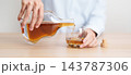 man pour cognac into a glass on table, suffering from alcohol addiction, alcoholism concept. depicting emotional distress, depression, substance abuse problem, unhealthy lifestyle and mental health 143787306