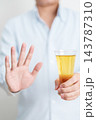 man making stop hand gesture to refuse a glass of Beer, Healthy man say no to alcohol drink, stop alcoholism and addiction concept. Responsible man reject a drink before driving and quit booze 143787310