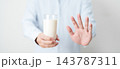 Lactose intolerance and Milk allergy. man hand stop and refuse Milk, having abdominal cramps and pain when drink Cow Milk. Symptom stomach ache, Dairy intolerant, Nausea, Bloating, Gas and Diarrhea 143787311