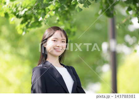 春の新緑が美しい屋外を笑顔カメラ目線、新卒の若い日本人女性社員、大学生の就活や新入社員イメージ 春の新緑が美しい屋外を笑顔カメラ目線、新卒の若い日本人女性社員、大学生の就活や新入社員イメージ 143788381