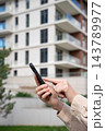 Tenant Searching Apartment Rentals On Smartphone Outside Residential Building. Buyer Browsing Property Listings In Real Estate App. Copy Space. 143789977