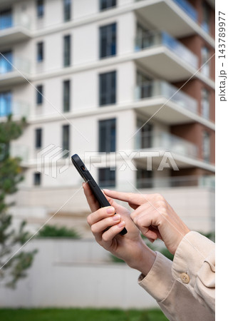 Tenant Searching Apartment Rentals On Smartphone Outside Residential Building. Buyer Browsing Property Listings In Real Estate App. Copy Space. Tenant Searching Apartment Rentals On Smartphone Outside Residential Building. Buyer Browsing Property Listings In Real Estate App. Copy Space. 143789977