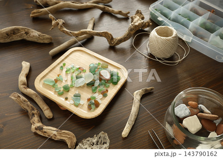 Sea glass diy craft workshop natural materials workspace. Creative hobby authentic flatlay background. Eco friendly art upcycling handmade home projects. Sea glass diy craft workshop natural materials workspace. Creative hobby authentic flatlay background. Eco friendly art upcycling handmade home projects. 143790162