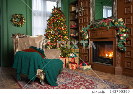 Classical Christmas decorated interior living room with fireplace. Christmas tree with red golden ornament decorations gift boxes. Modern classic style interior design apartment. Christmas eve at home Classical Christmas decorated interior living room with fireplace. Christmas tree with red golden ornament decorations gift boxes. Modern classic style interior design apartment. Christmas eve at home 143790399