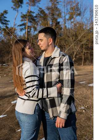 Young Couple Embracing Under Blanket During Winter Road Trip Young Couple Embracing Under Blanket During Winter Road Trip 143790610