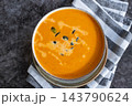 Smooth texture natural colors and fresh dairy contrast beautifully with the garnish of Creamy Pumpkin Soup Garnished with Pumpkin Seeds. Concept of homemade cooking seasonal ingredients 143790624