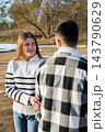 Young Couple Embracing Under Blanket During Winter Road Trip 143790629