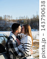 Young Couple Embracing Under Blanket During Winter Road Trip 143790638