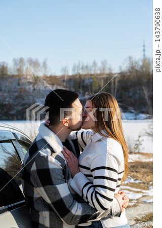 Young Couple Embracing Under Blanket During Winter Road Trip 143790638
