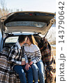 Young Couple Embracing Under Blanket During Winter Road Trip 143790642