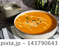 Smooth texture natural colors and fresh dairy contrast beautifully with the garnish of Creamy Pumpkin Soup Garnished with Pumpkin Seeds. Concept of homemade cooking seasonal ingredients 143790643