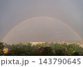 Weather conditions light interaction and beauty of nature. Soft daylight illuminates the clouds and enhances the vivid rainbow arc. Concept of hope optimism tranquility meteorology climate, and 143790645