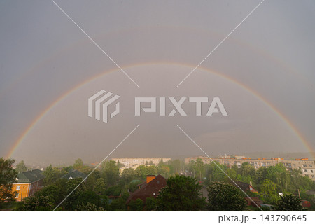 Weather conditions light interaction and beauty of nature. Soft daylight illuminates the clouds and enhances the vivid rainbow arc. Concept of hope optimism tranquility meteorology climate, and Weather conditions light interaction and beauty of nature. Soft daylight illuminates the clouds and enhances the vivid rainbow arc. Concept of hope optimism tranquility meteorology climate, and 143790645