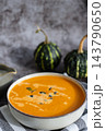 Smooth texture natural colors and fresh dairy contrast beautifully with the garnish of Creamy Pumpkin Soup Garnished with Pumpkin Seeds. Concept of homemade cooking seasonal ingredients 143790650
