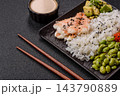An Asian style bowl with shrimp, edamame, tomatoes, and wakame. A shrimp and vegetable bowl 143790889
