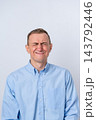 Man in a light blue shirt grimacing strongly, squeezing eyes shut and wrinkling his nose, indicating an intense feeling of disgust, discomfort, or an adverse reaction 143792446