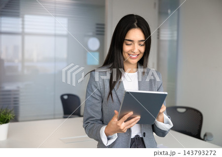 Businesswoman working on project on digital tablet in office 143793272