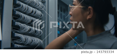 IT Technician Wearing Headset and Reviewing Network Connections on Tablet IT Technician Wearing Headset and Reviewing Network Connections on Tablet 143793334