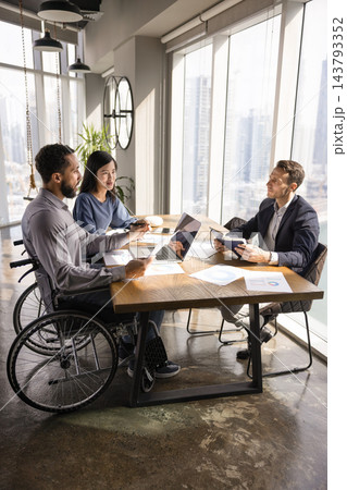 Inclusive team of business professionals holding meeting in office Inclusive team of business professionals holding meeting in office 143793352