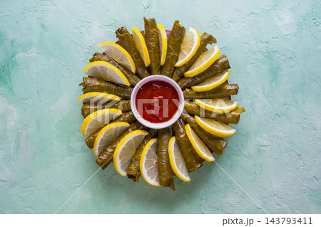 Traditional Stuffed Grape Leaves Dolma with Lemon and Red Sauce 143793411
