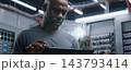 Male IT Manager Consulting Female Network Technician While Female Tests Ethernet Connections 143793414