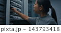 IT Technician Wearing Headset and Reviewing Network Connections on Tablet  143793418