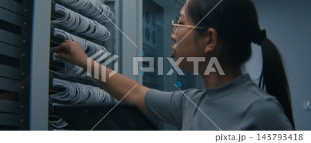 IT Technician Wearing Headset and Reviewing Network Connections on Tablet IT Technician Wearing Headset and Reviewing Network Connections on Tablet 143793418