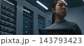 IT Engineer Examining High Density Network Ports, Cable Connections While Reviewing Data on Tablet 143793423