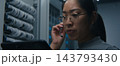 Female Network Engineer Using Tablet and Headset to Coordinate Technical Tasks 143793430