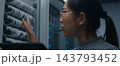 Female Network Engineer Using Tablet and Headset to Coordinate Technical Tasks 143793452