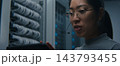 Female Network Engineer Using Tablet and Headset to Coordinate Technical Tasks 143793455