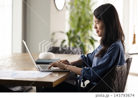 Woman working on laptop in modern home office 143793674