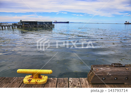 Dockside Waterfront View with Yellow Mooring Bollard and Pier in Port Angeles Dockside Waterfront View with Yellow Mooring Bollard and Pier in Port Angeles 143793714