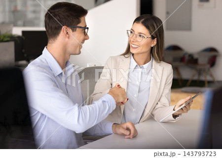 Happy young Latin male and female business colleagues getting agreement Happy young Latin male and female business colleagues getting agreement 143793723