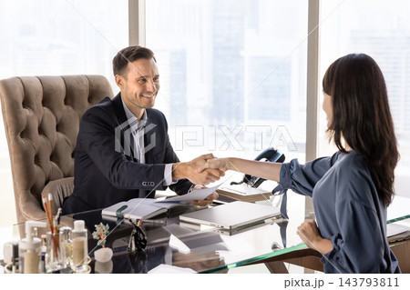 HR manager shake hands job applicant during meeting in office HR manager shake hands job applicant during meeting in office 143793811