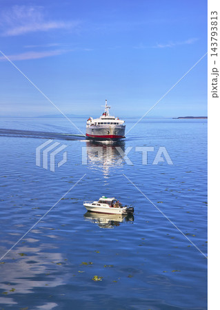 Ferry and Boat on Calm Water with Blue Sky in Port Angeles Washington Ferry and Boat on Calm Water with Blue Sky in Port Angeles Washington 143793813