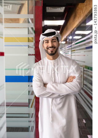 Middle Eastern businessman posing in office hallway Middle Eastern businessman posing in office hallway 143793863