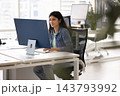 South Asian businesswoman developing project on computer in modern office 143793992