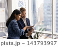 Diverse multiethnic colleagues brainstorming ideas using tablet at urban office 143793997