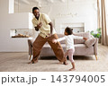 Happy black father dancing to music with toddler daughter 143794005