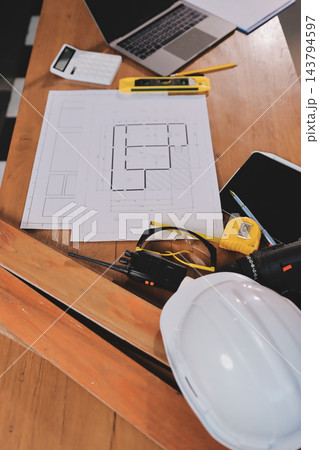 Asian architect and engineer team checking architectural house model using measuring tape on the table at office studio. Asian architect and engineer team checking architectural house model using measuring tape on the table at office studio. 143794597