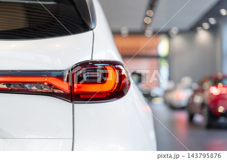 rear view of new modern white car led tail lights in showroom 143795876