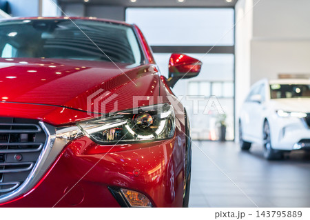 front view of new modern white car led headlight in showroom front view of new modern white car led headlight in showroom 143795889
